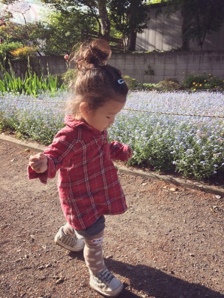 Yuto walking in a flower garden