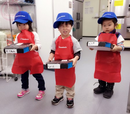 Thee newly hired Domino's little staffs.